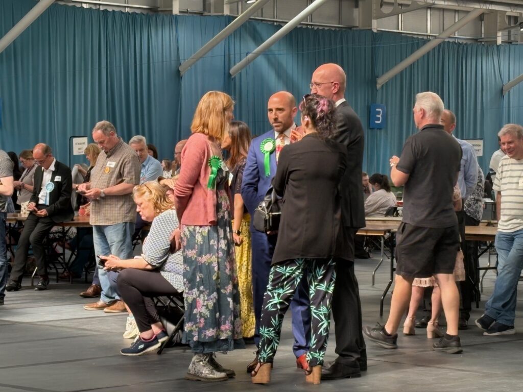 Green Party representatives wait for the results.