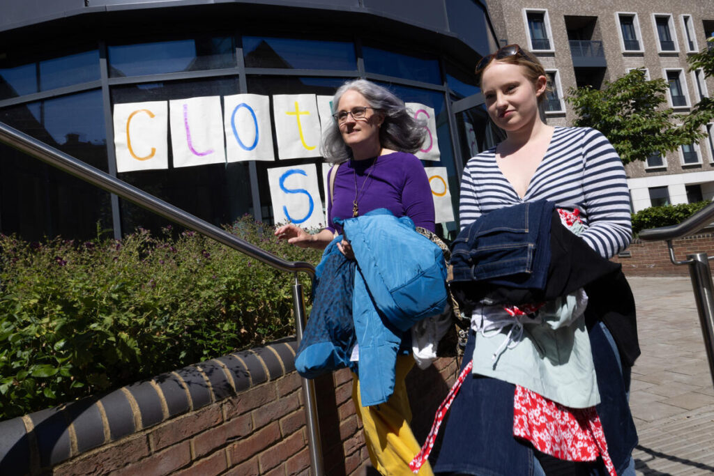 Greenpeace UK volunteers in St Albans organise a free clothes swap event, with the opportunity to raise funds for Greenpeace by donating via a QR code.