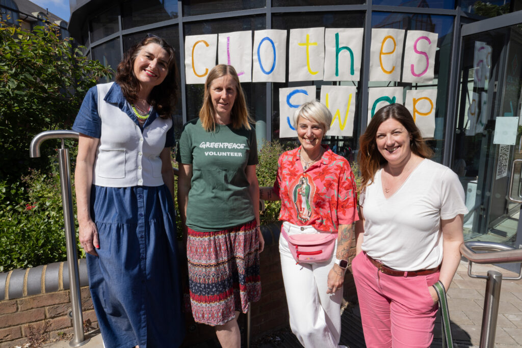 Greenpeace UK volunteers in St Albans organise a free clothes swap event, with the opportunity to raise funds for Greenpeace by donating via a QR code.