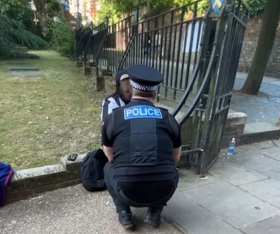 A police officer talks to the man in Waxhouse Gate.