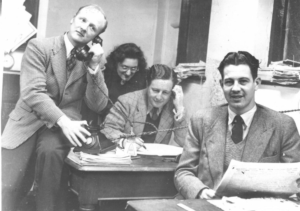 Back from the war: Douglas Walton, who had been a radio operator in the Merchant Navy, Beryl Carrington, “Desert Rat” George Davies and Roy Bentley who was in the RAF, in the Dagnall Street newsroom. (Below) Stopping for a snack on an office outing.