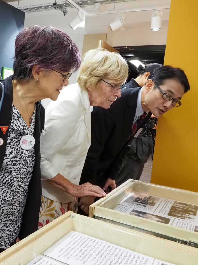 L to R Zoe Reed, Chair Emirata, Society fof Anglo Chinese Understanding, Mary Smart, Bi Haibo Minister Counsellor, Chinese Embassy studying the George Hogg Exhibition