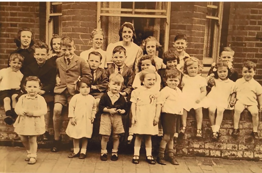 The front cover of Down Our Way features this photo of the King’s Road VE Day party.