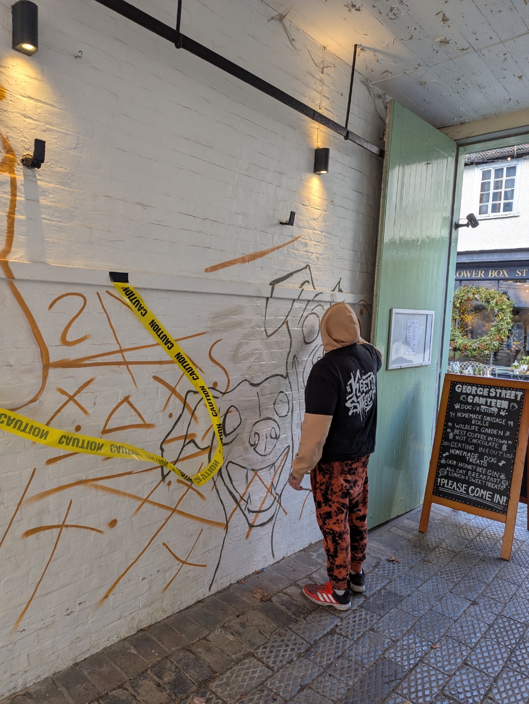 Ant Steel working on the mural at George Street Canteen