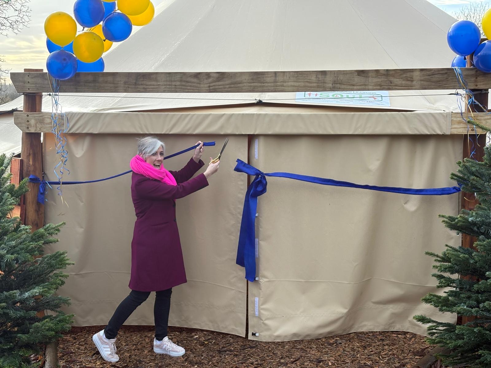 Daisy Cooper opens The Abbey CE VA Primary School's outdoor canopy space.