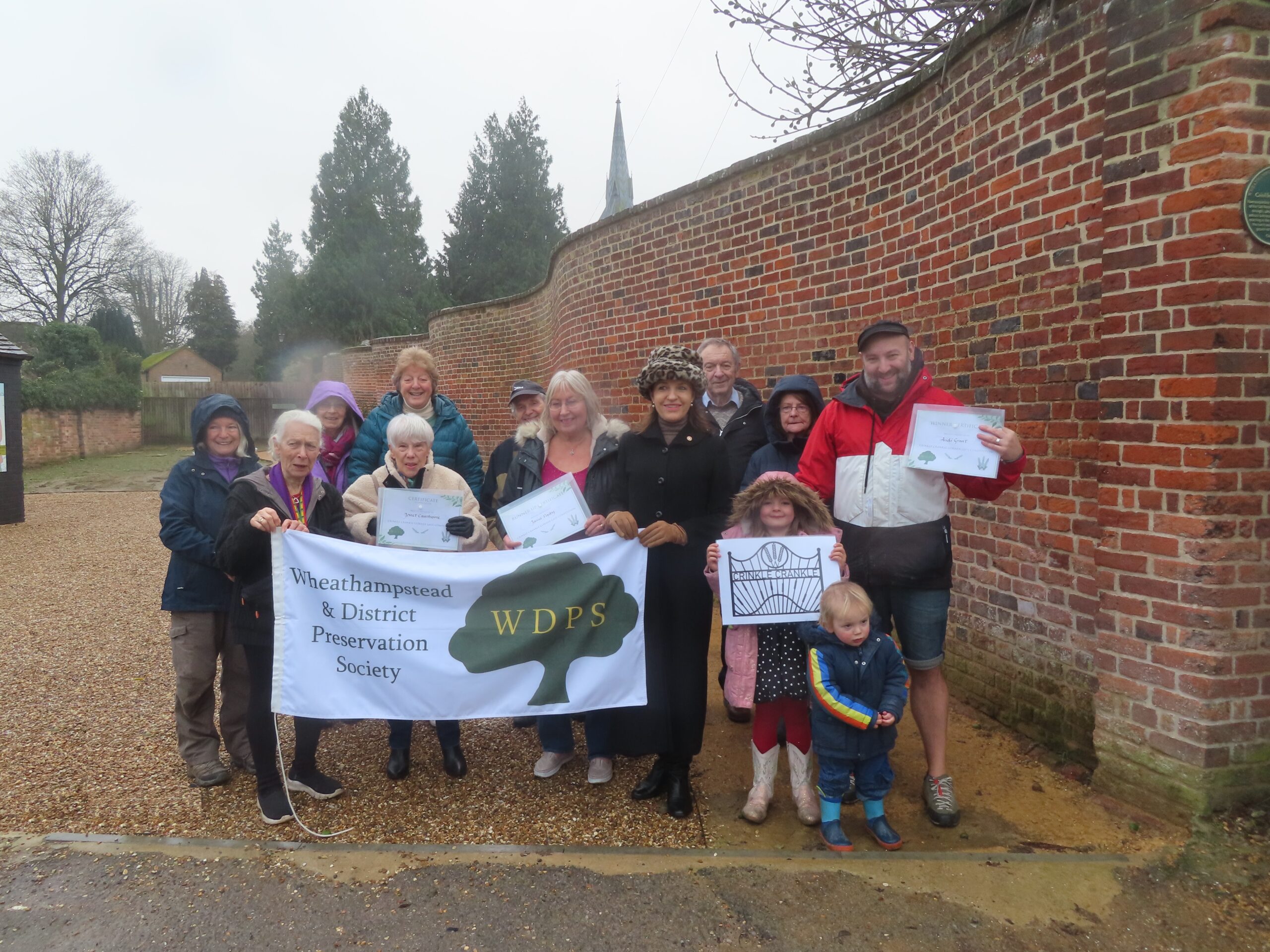 Brave souls in the rain at the announcement of the winning Crinkle Crankle Corner gate design in Wheathampstead.