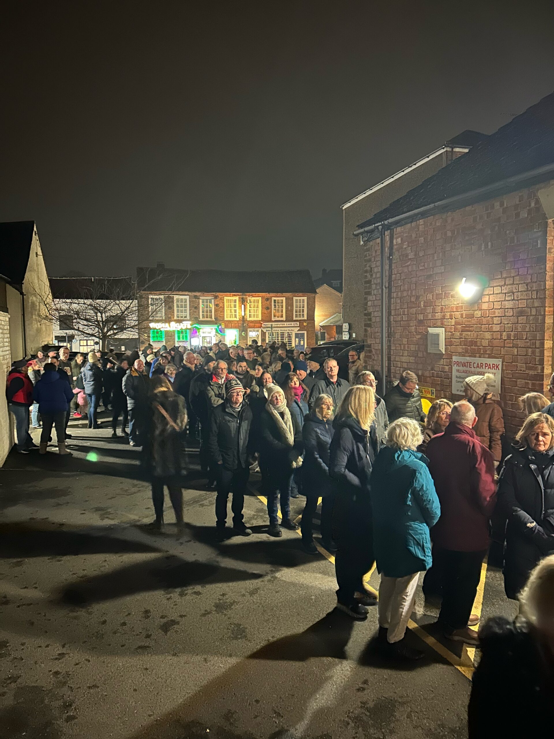Villagers gather outside Redbourn village hall in opposition to housing developments in the village.
