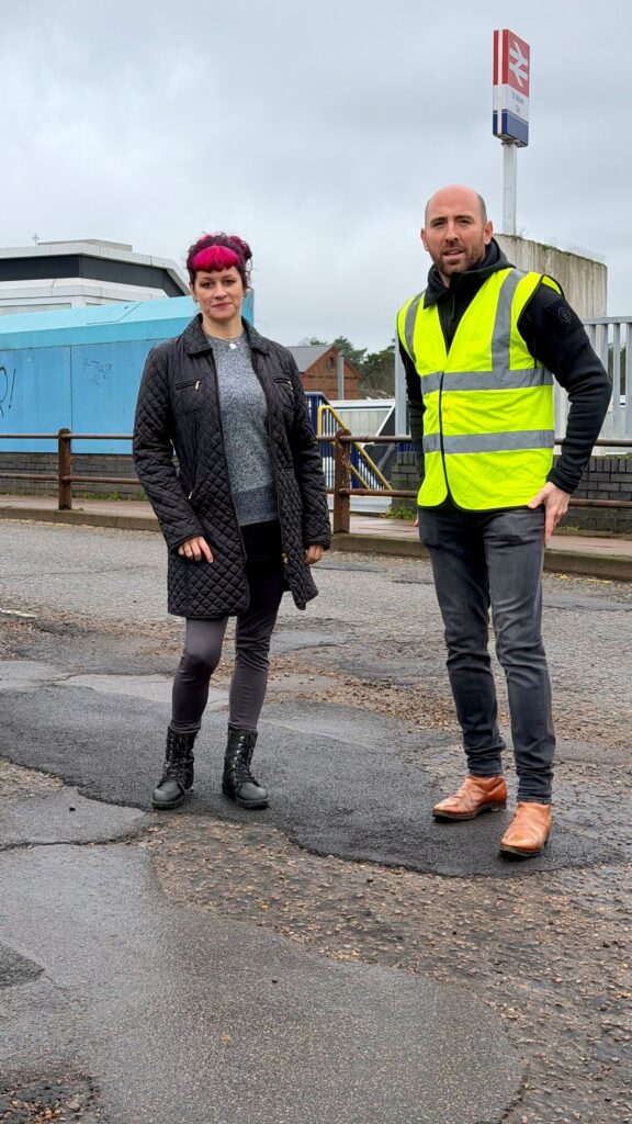 Green Party campaigner Sally Leonard with Cllr Matt Fisher on Victoria Street railway bridge.