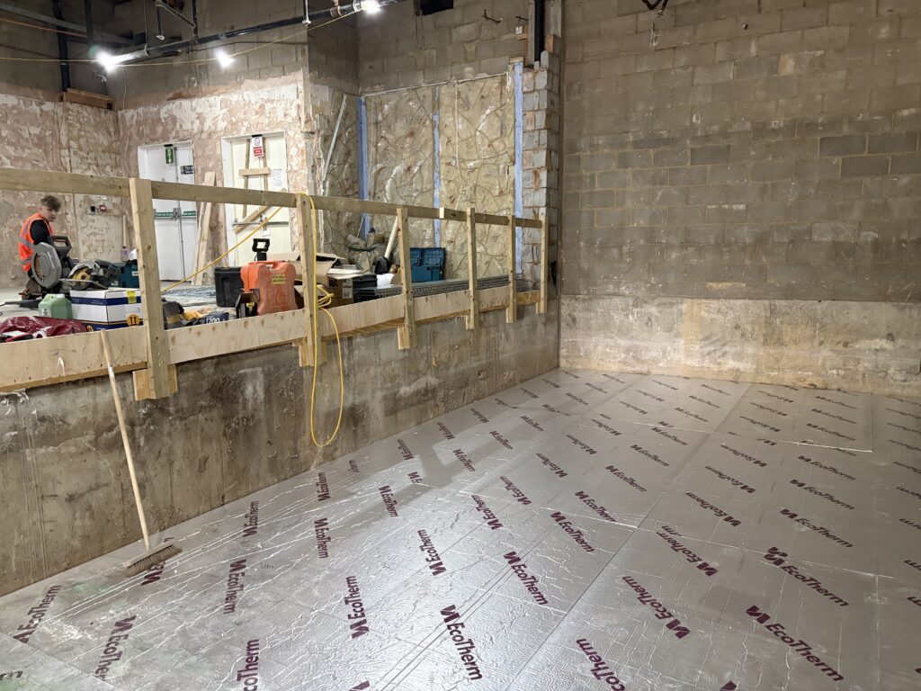 The seating area of the ground floor can be seen in the foreground.