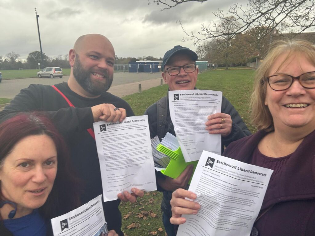 Cllr Lynn Cunningham, right, and Cllr Paul de Kort, second right, delivering leaflets about the community hub proposals to New Greens residents.