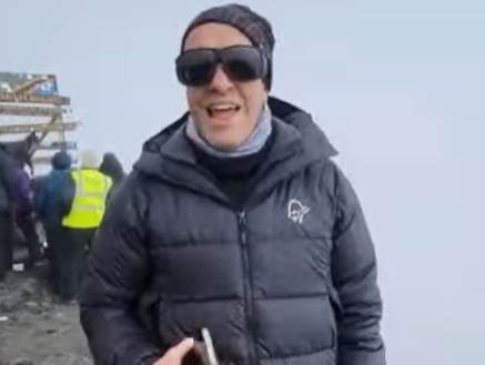 Alastair Woodgate at the summit of Mount Kilimanjaro