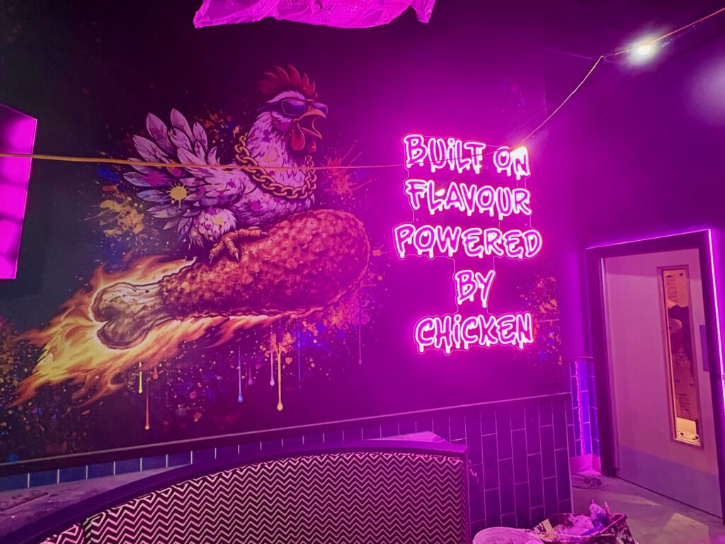 One of the illuminated signs inside Chicken George.