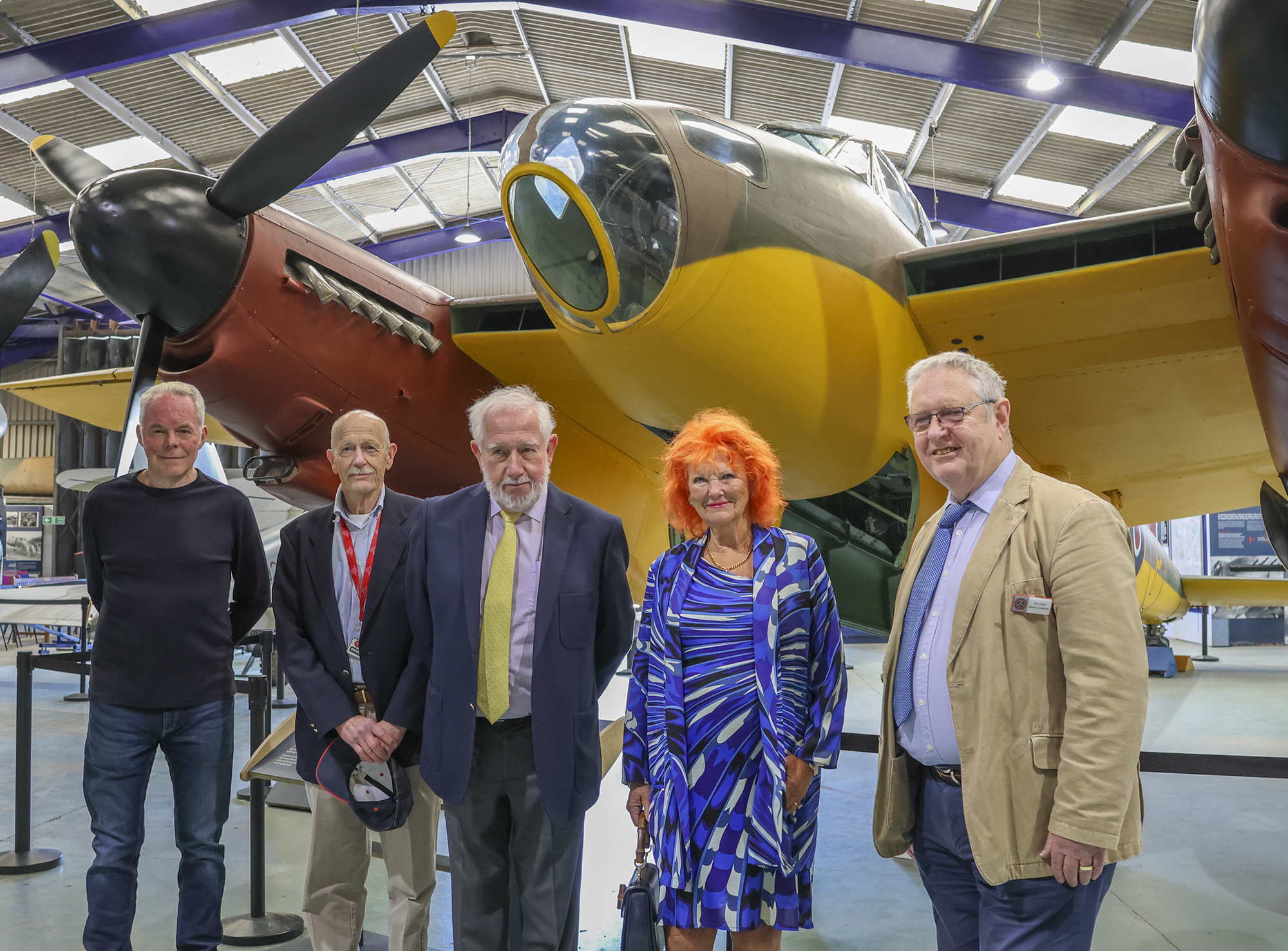 Guests pose in front of the prototype Mosquito: (left to right) Ian Thirsk, John Hatton (museum volunteers) Stuart Wilkinson, Jerry Swift and Lady McAlpine (National Transport Trust)