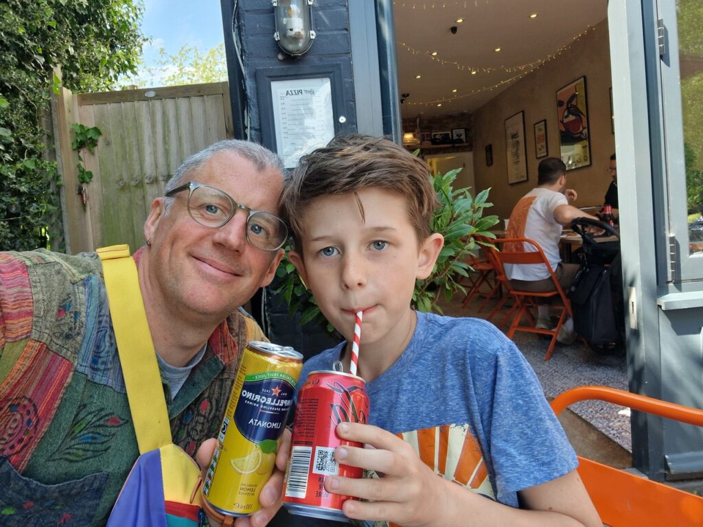 Chris and Cal at Gracey’s Pizza, where they now go as a ritual every month before Rising Sons;