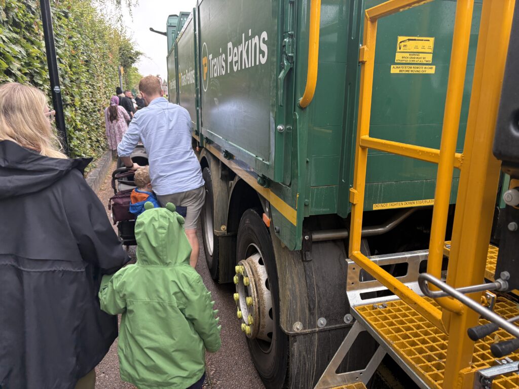 Parents and children struggle to get past the delivery truck.